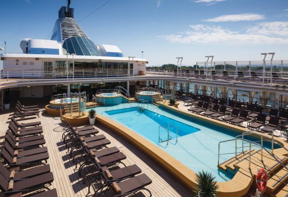 A large swimming pool on the deck of a cruise ship