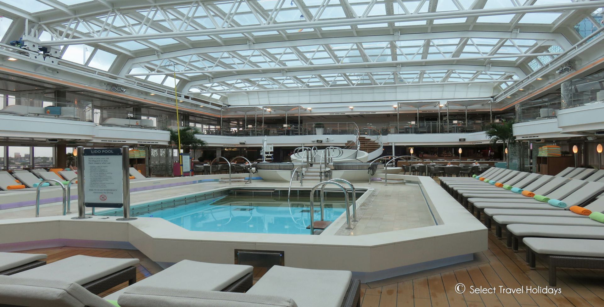 there is a large swimming pool on the deck of a cruise ship .