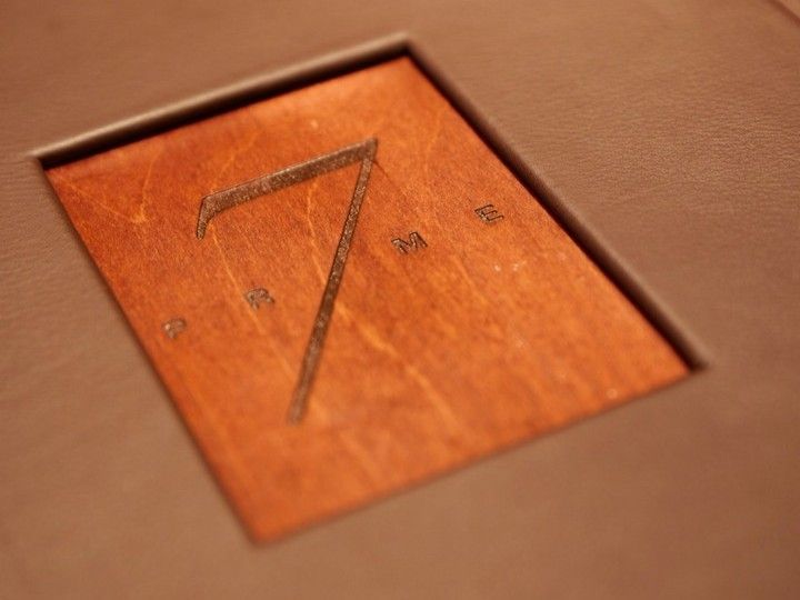 The number 7 is carved into a piece of wood