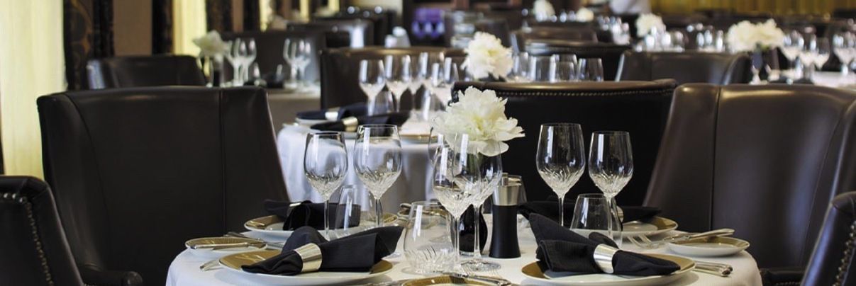 A dining room with a table set with plates and glasses called prime 7 onboard seven seas voyager