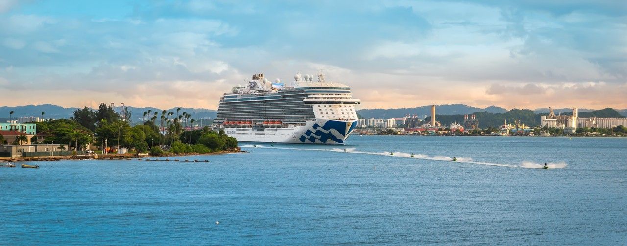 A large princess cruise ship is floating on top of a body of water on a world cruise.