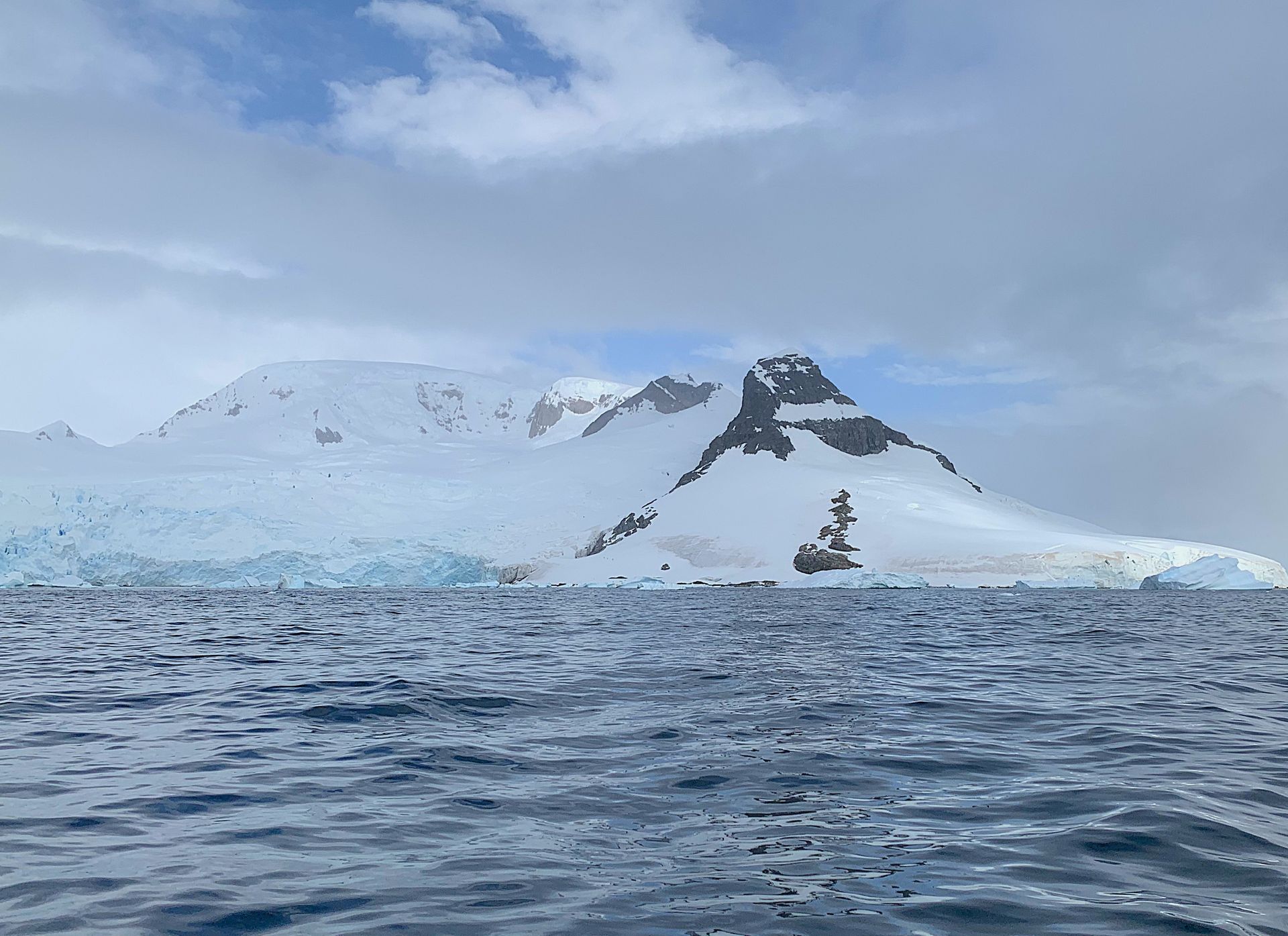 A large body of water with a mountain in the background