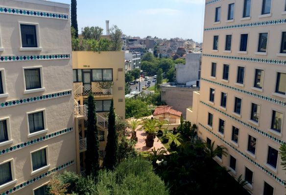 A large hotel with a lot of windows and trees in front of it