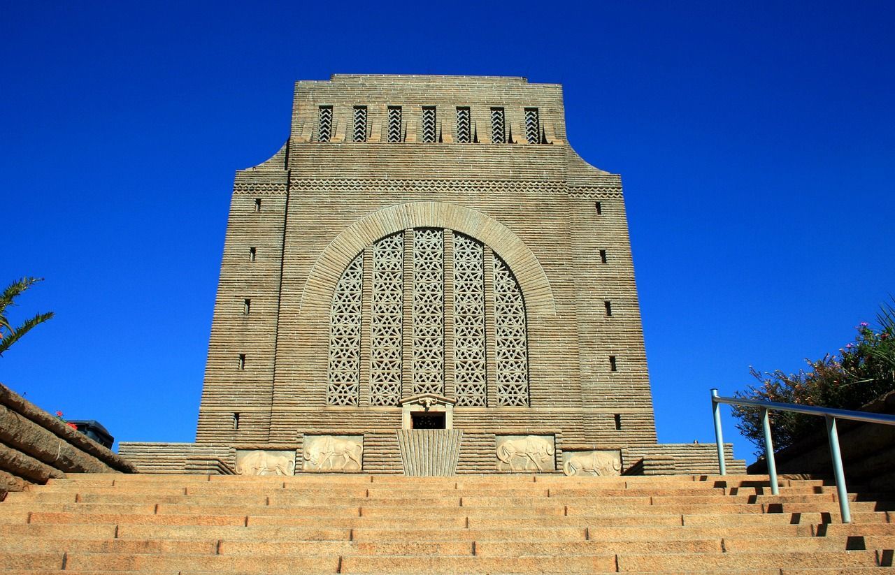 A building with stairs leading up to it and a blue sky in the background