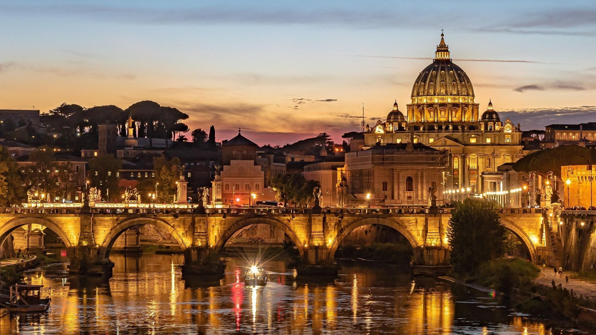 a bridge over a river with a dome in the background in Rome