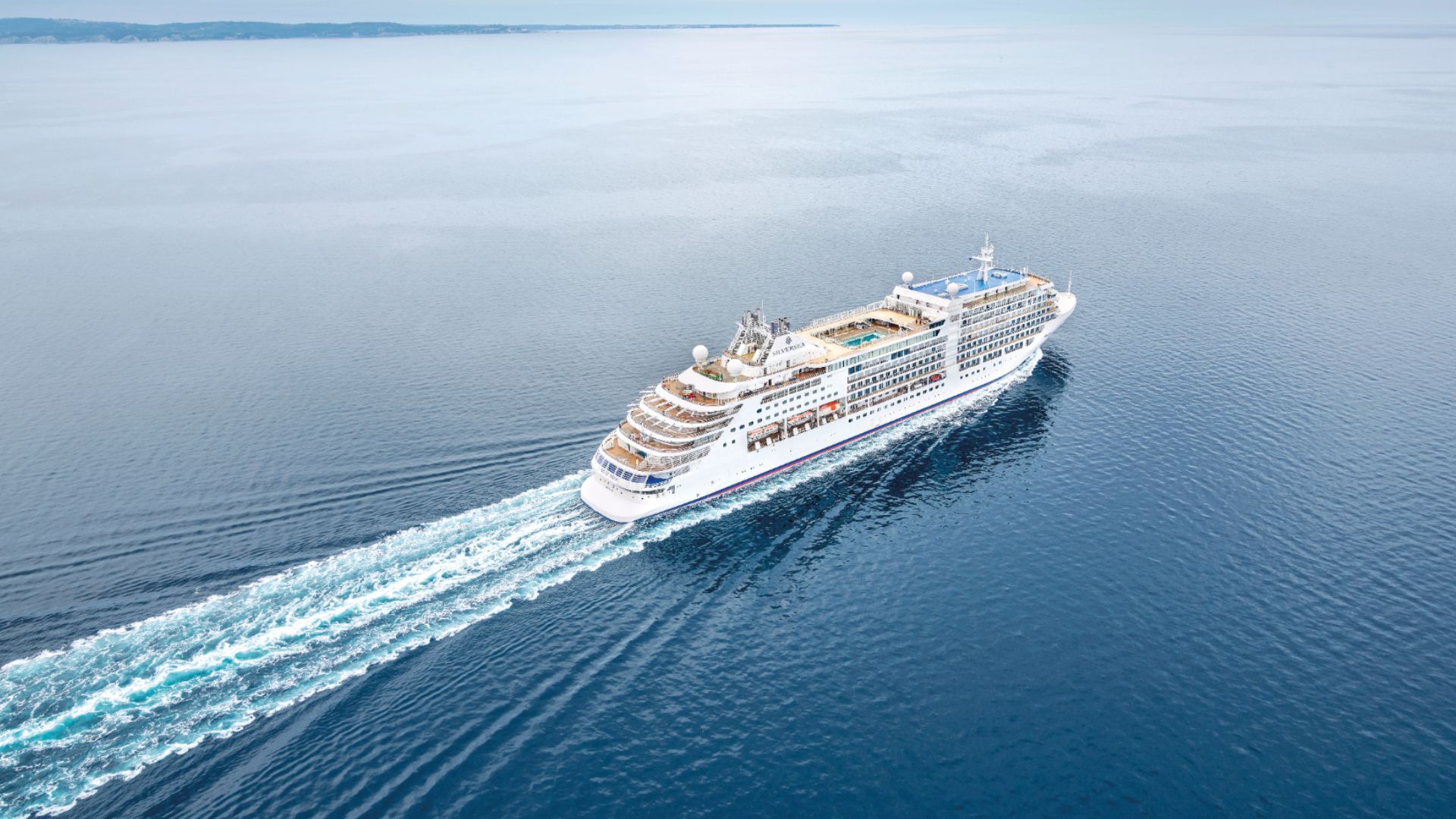 An aerial view of a silver shadow cruise ship on 2028 world cruise for silversea