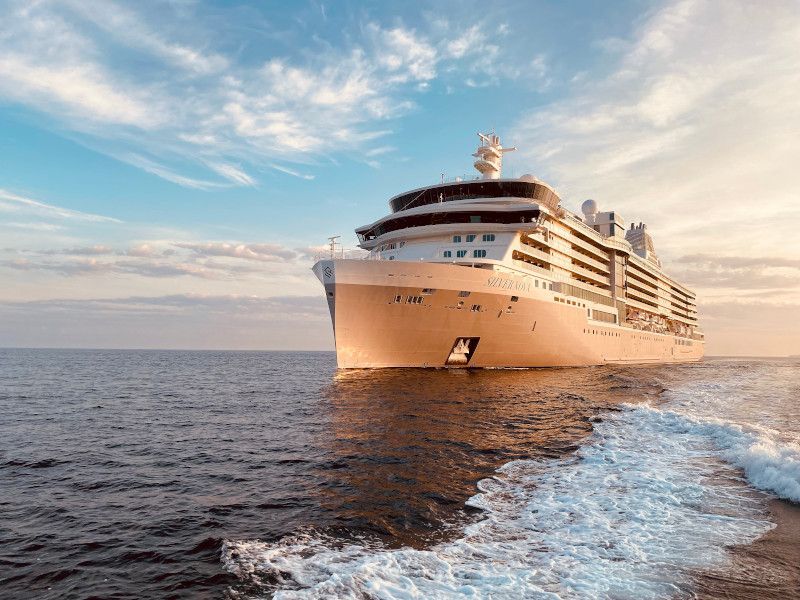 A large cruise ship is floating on top of a large body of water.