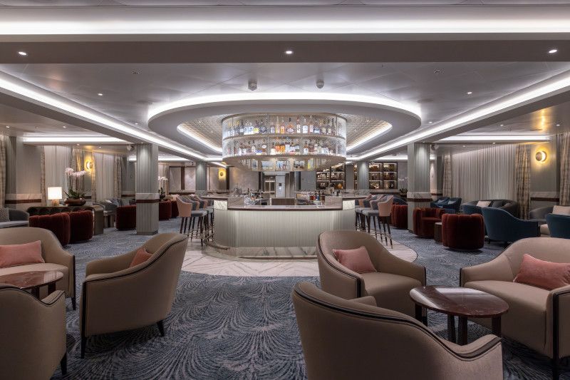 A large room filled with furniture and a bar on a cruise ship on Silver Nova cruise ship
