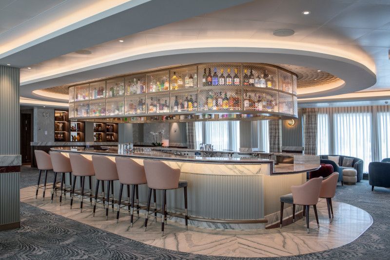 There is a long bar with a lot of bottles on it on Silver Nova cruise ship