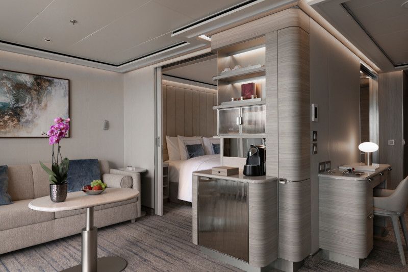 A medallion suite with a couch , table , chairs and a bed on Silver Nova cruise ship