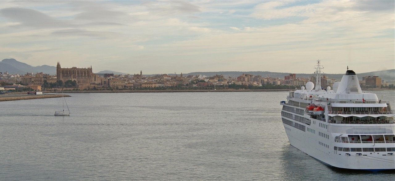 A Silversea cruise ship is floating on top of a body of watet on a world cruise