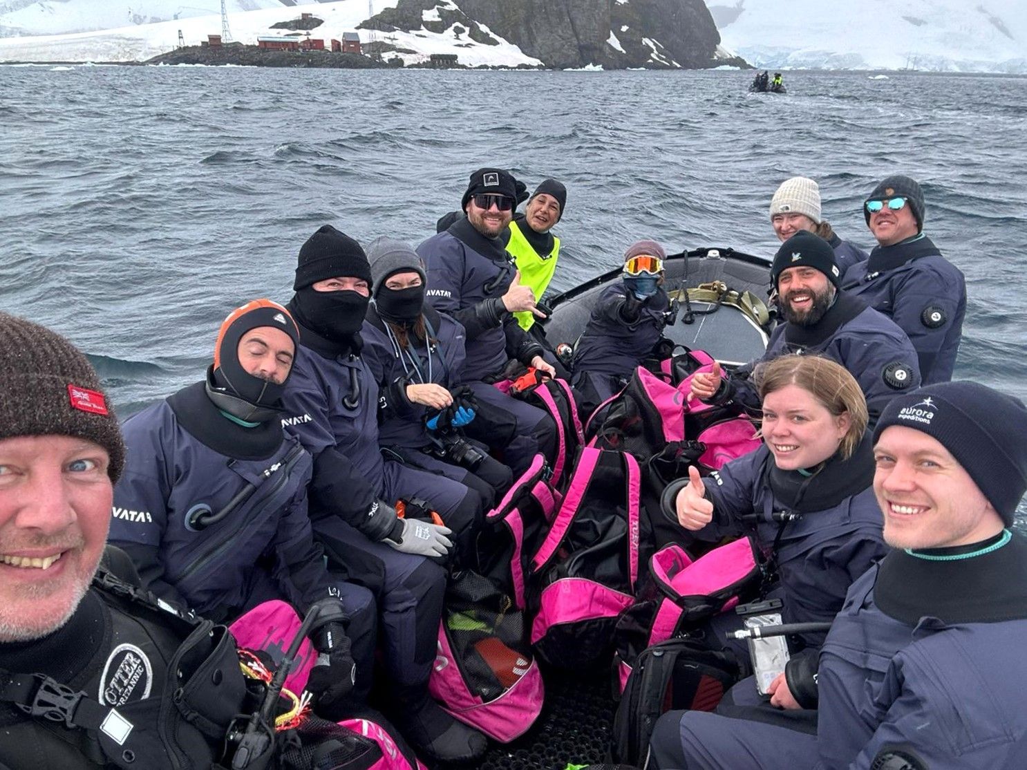 A group of people are sitting on a boat in the water.