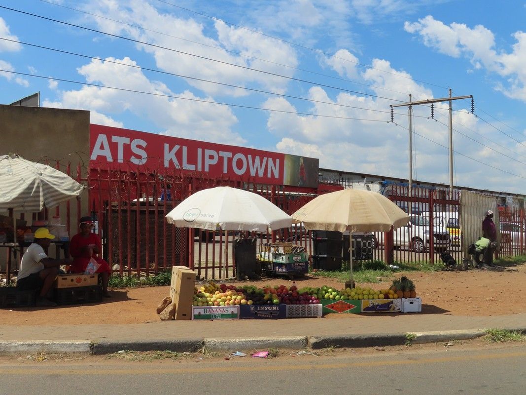 A red sign that says ats kliptown on it