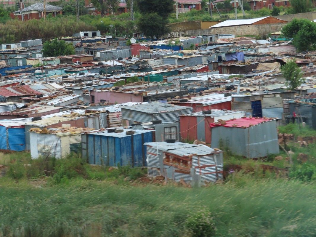 A slum area with a lot of shacks and buildings