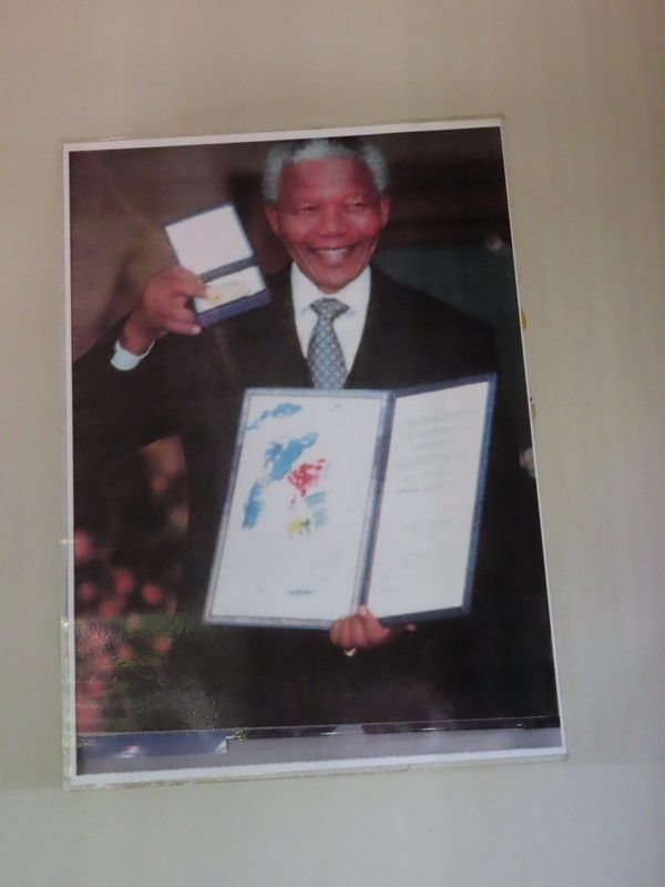 A man in a suit and tie is holding a book