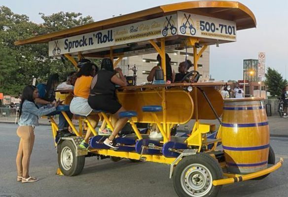 a group of people are sitting at a bar on a bicycle, Sprock & Roll in Memphis