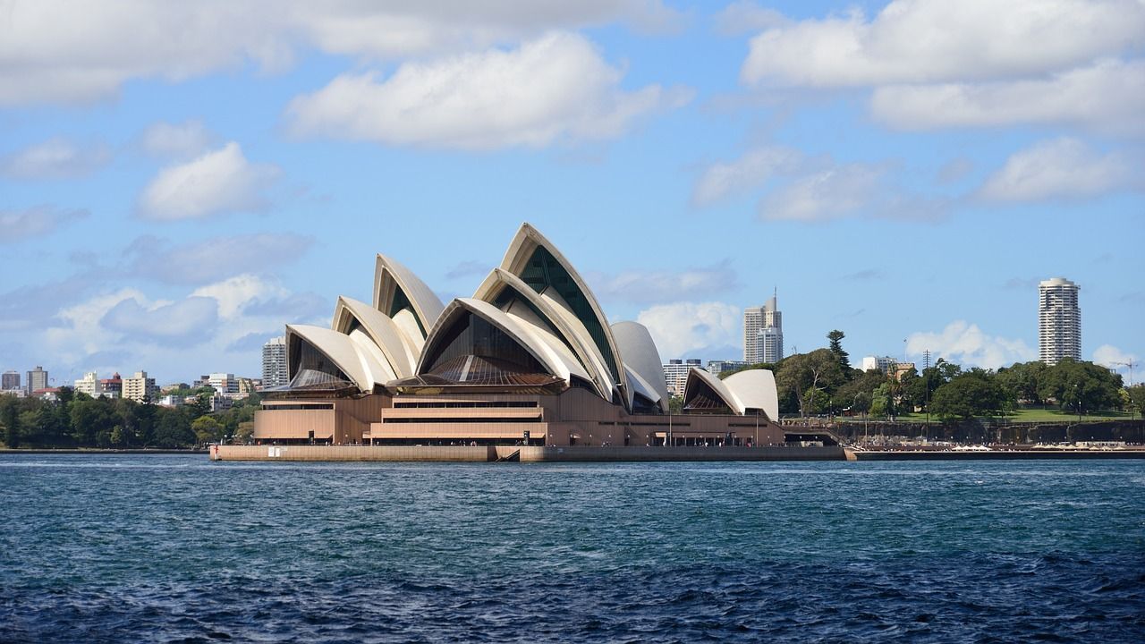 The sydney opera house is floating on top of a body of water.