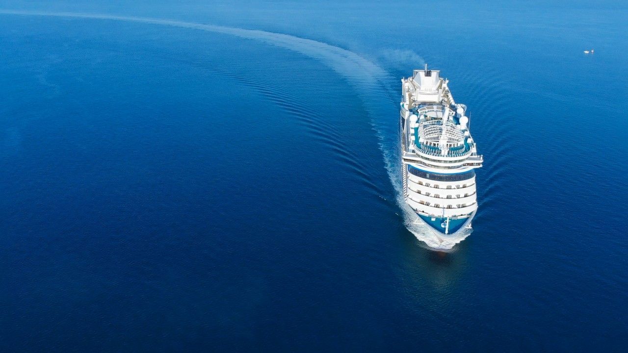 An aerial view of a cruise ship in the ocean.