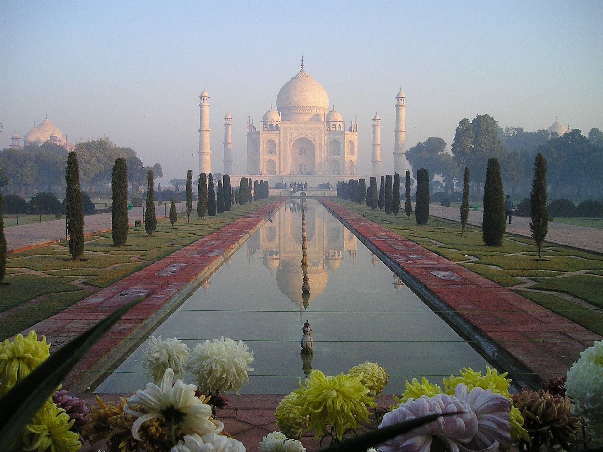 A reflection of the taj mahal in a pond in the foreground on a golden triangle tour with intrepid