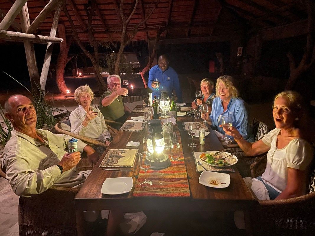A group of people are sitting at a table drinking wine.