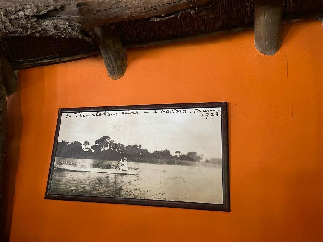 A black and white photo of a river is hanging on a wall.