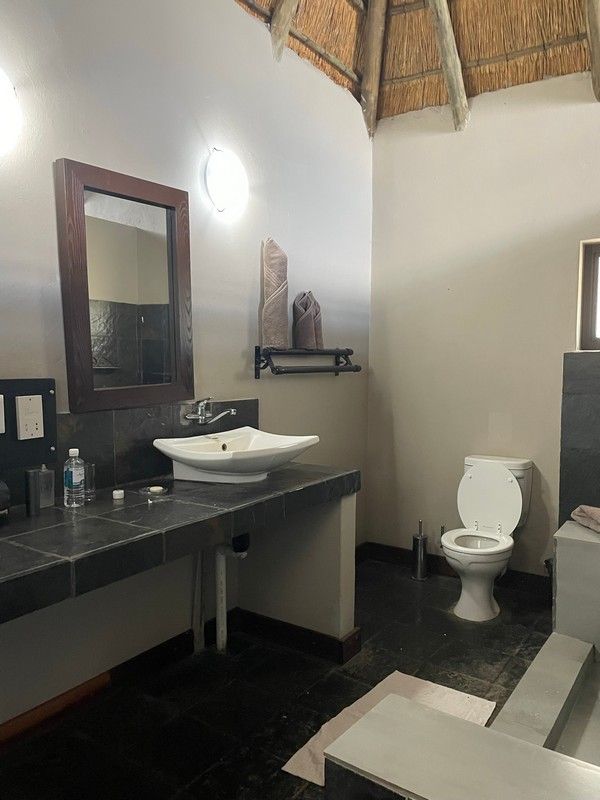 A bathroom with a sink , toilet and mirror
