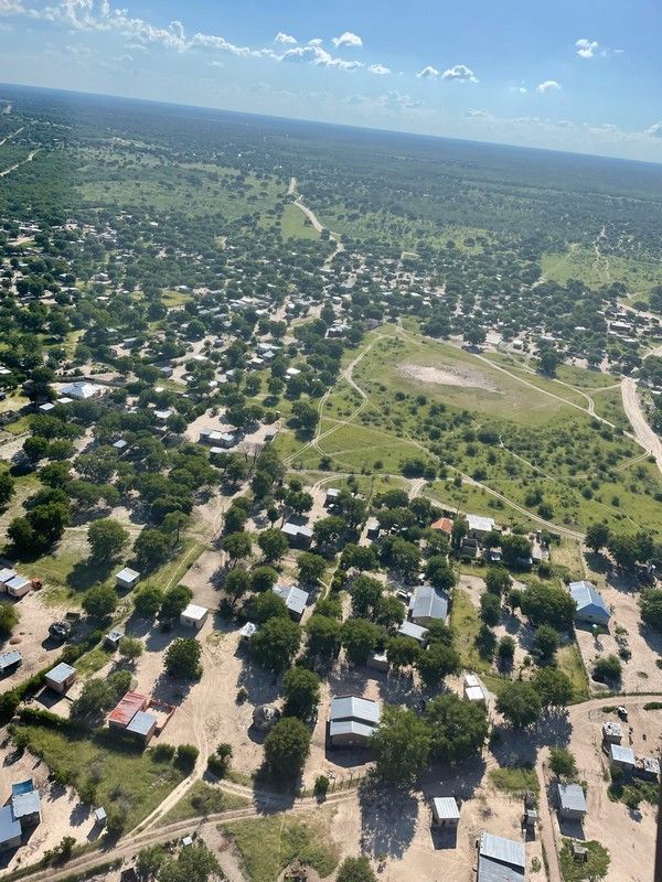 An aerial view of a small town surrounded by trees