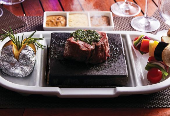 A plate of food with a steak and vegetables on it