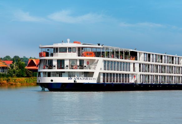 A large cruise ship is floating on top of a large body of water.