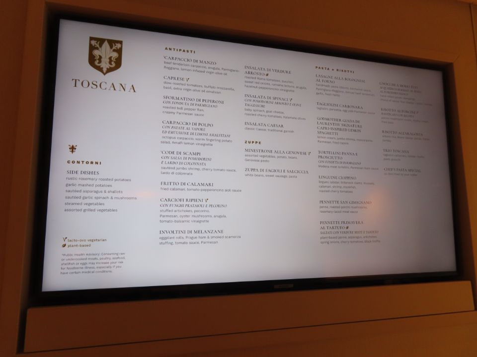 A tv screen displays a menu for toscana