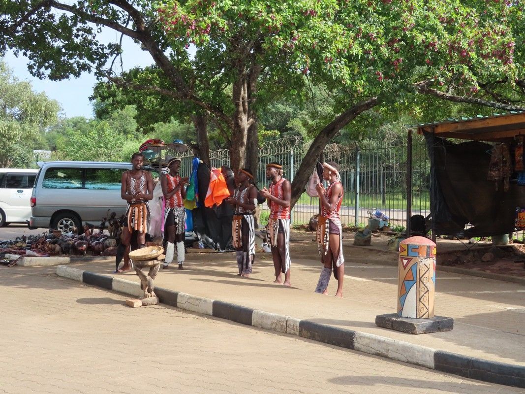 A group of people are dancing on the side of the road.