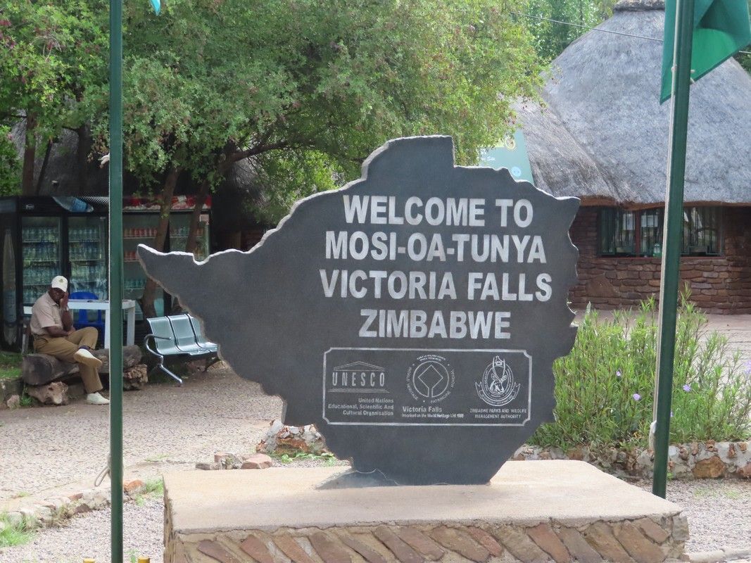 A sign that says welcome to mosi-oa-tunya victoria falls zimbabwe
