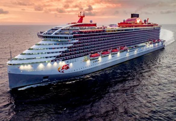 A large cruise ship is floating on top of a body of water bearing the Virgin Voyages cruise logo