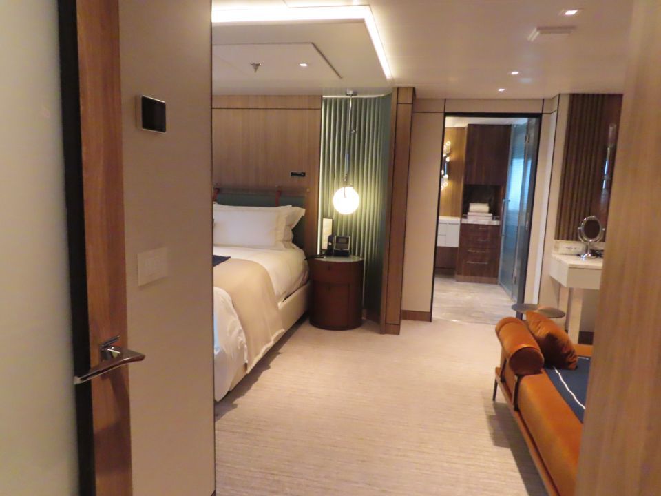 A cruise room with a bed and a couch in it