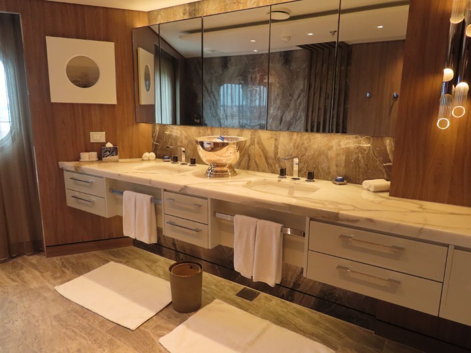 A bathroom with two sinks and a large mirror.