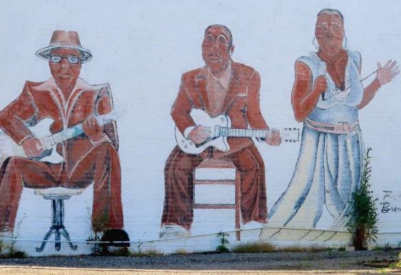 a mural of a man playing a guitar and a woman singing on Wall Art, Clarksdale, Mississippi