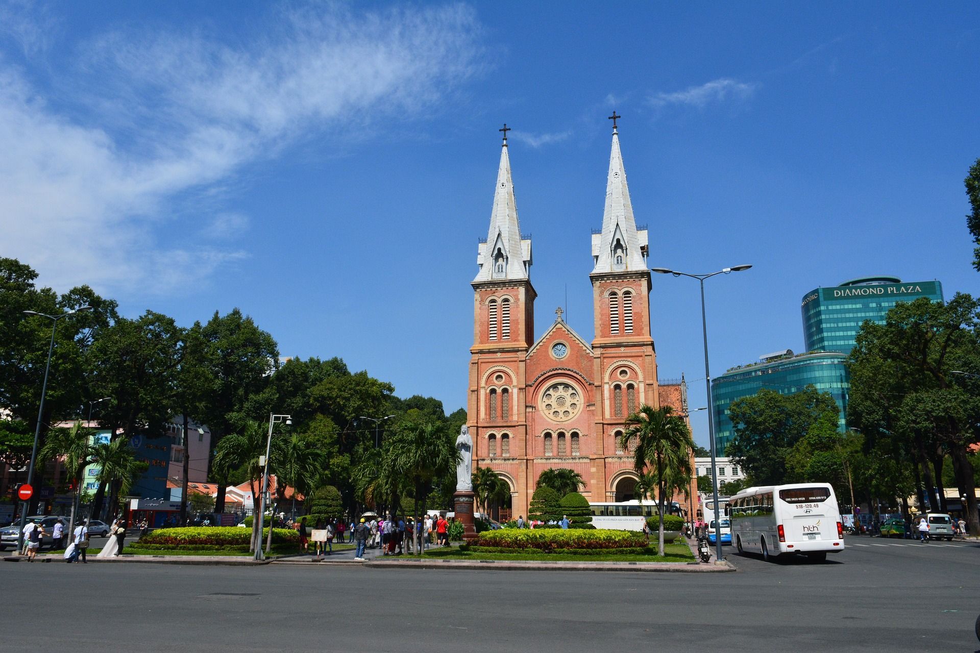 A large church with two towers is in the middle of a city in Ho Chi Minh City