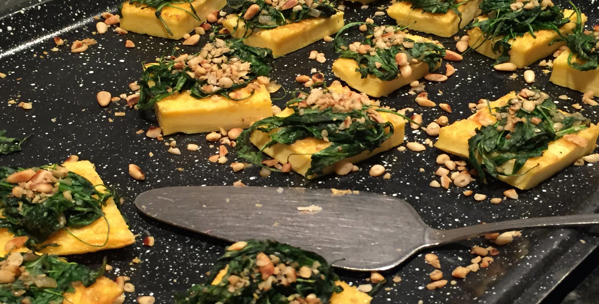 A tray of food with a spatula on it