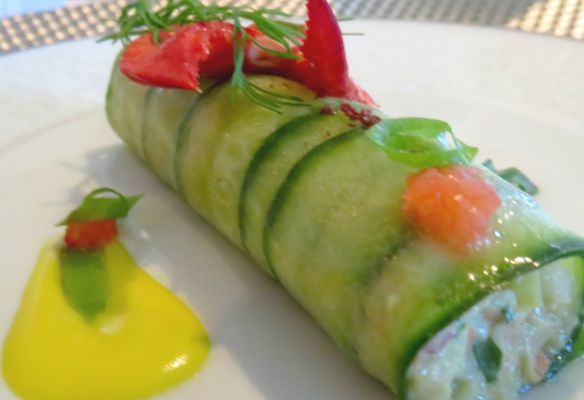 a close up of a cucumber roll on a white plateLobster and avocado salad rolled in a Lebanese cucumber