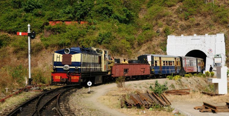 A train is going through a tunnel on the tracks.