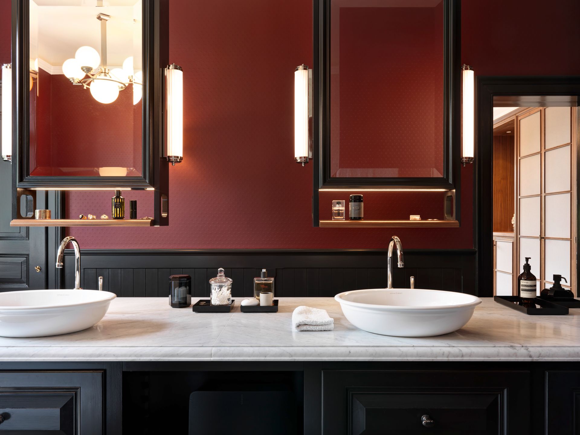 Ein Badezimmer mit zwei Waschbecken und zwei Spiegeln an der Wand.