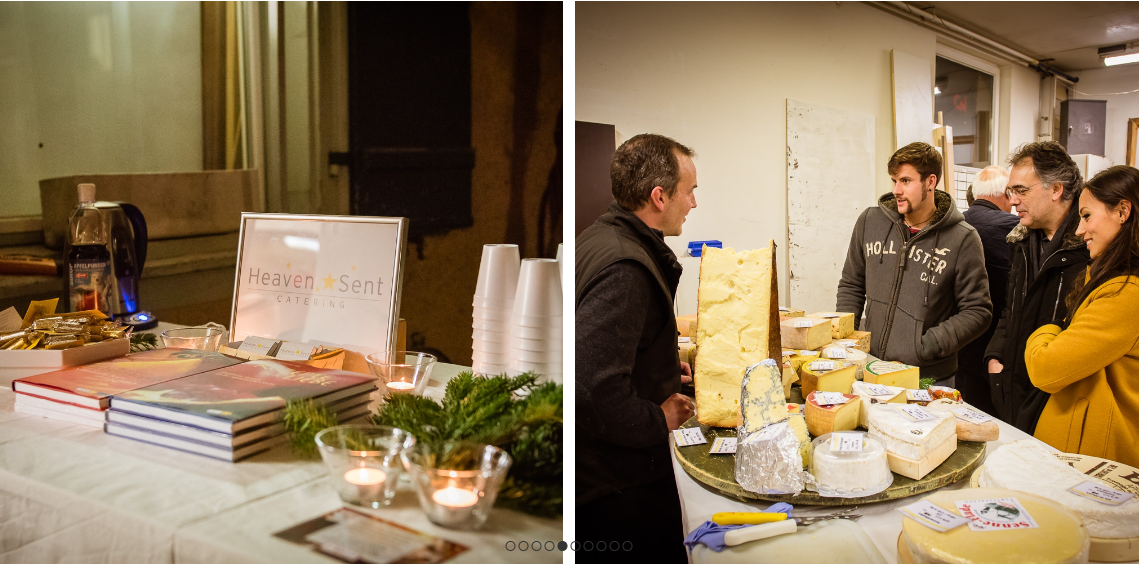 Eine Gruppe von Leuten steht mit Käse um einen Tisch herum.