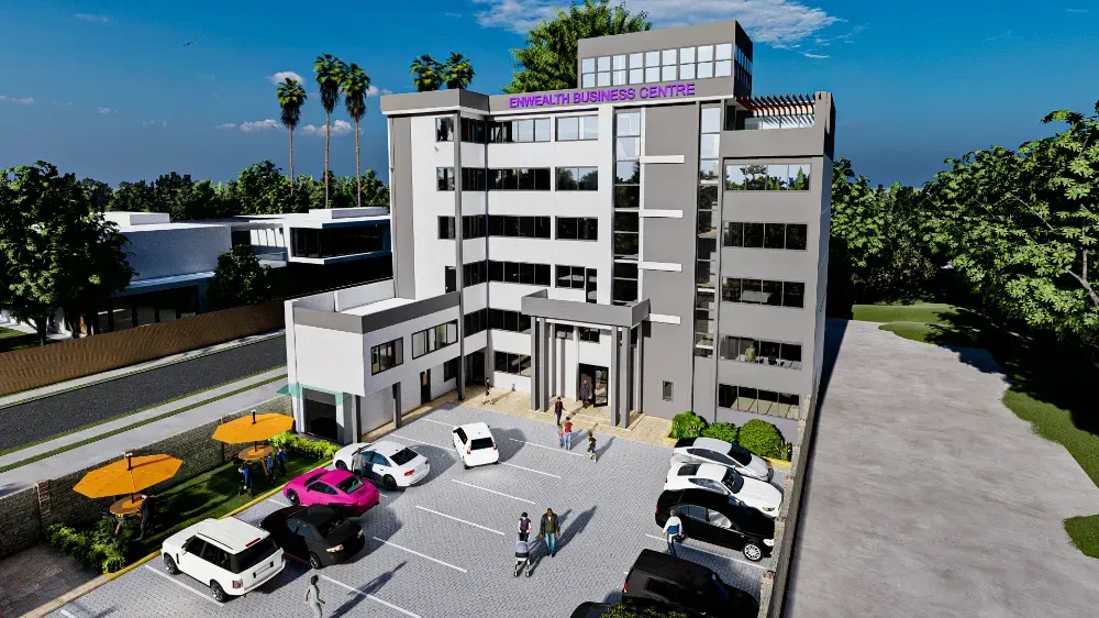 An aerial view of a large building with cars parked in front of it.