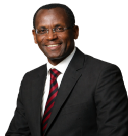 A man in a suit and tie is standing in front of a white background.