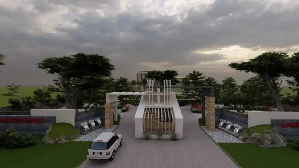 A white van is driving down a road in front of a gate.