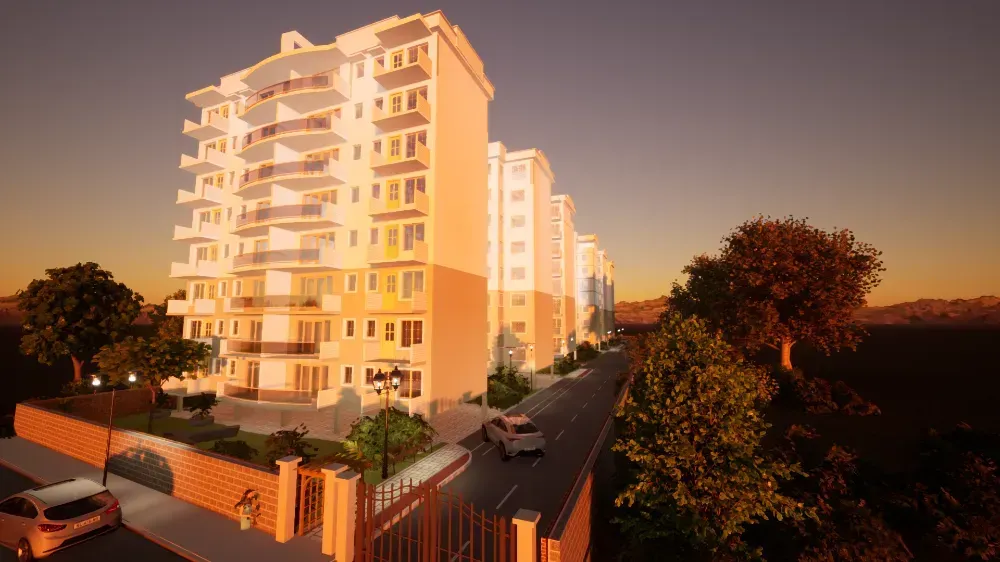 An aerial view of a building with cars parked in front of it at sunset.
