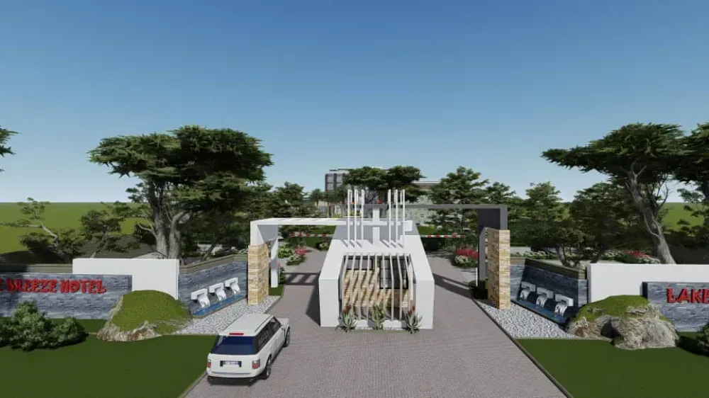 A white van is driving down a road in front of a building.