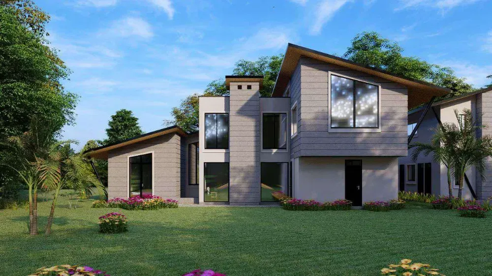 A large house with a lot of windows is sitting on top of a lush green field.