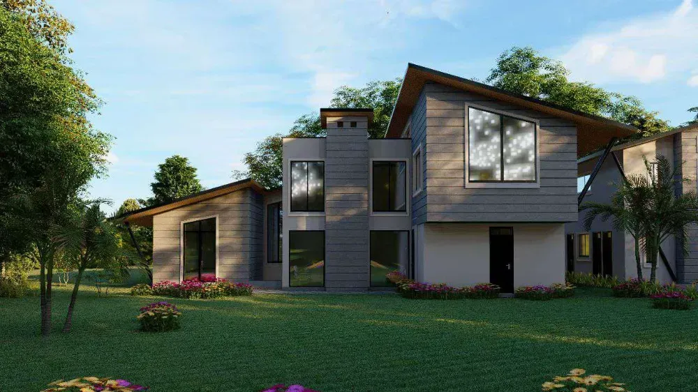 A large house with a lot of windows is sitting on top of a lush green field.