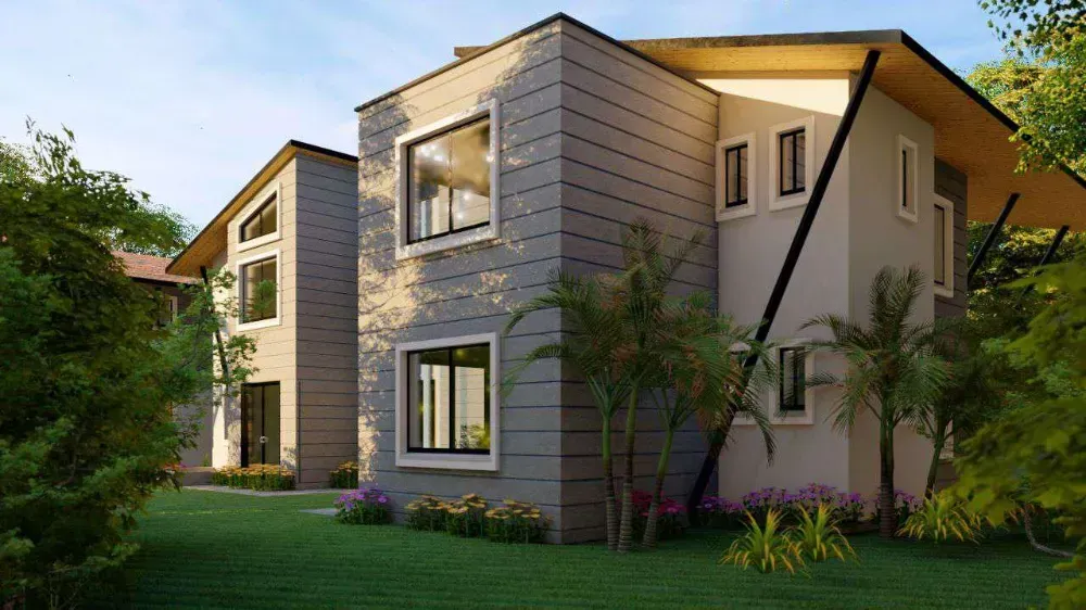 A large house with a lot of windows is surrounded by trees and grass.